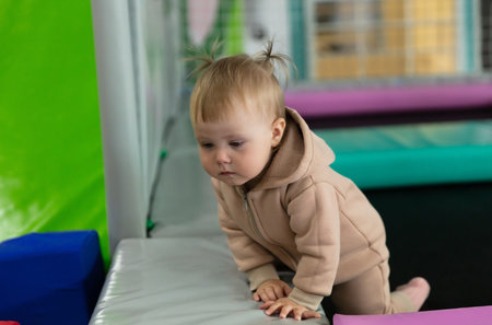 Little cute baby plays in a children's entertainment center