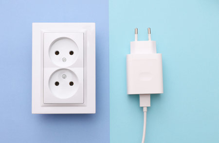Electrical sockets with charging adapter on blue background