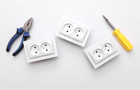 Electrical sockets, Screwdriver and pliers on a white background. Repair conceptの写真素材