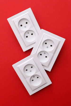 Electrical sockets on a red background