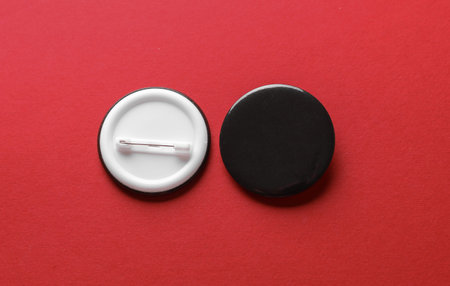 Black round pin button badge mockup on red background