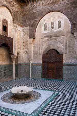 One of the highlights in Fez is the Al Attarine Madrasa. The coutyard of this place is a fine example of intricate Islamic architecture in Fez, Moroccoのeditorial素材