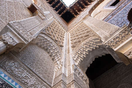 One of the highlights in Fez is the Al Attarine Madrasa. The coutyard of this place is a fine example of intricate Islamic architecture in Fez, Moroccoのeditorial素材