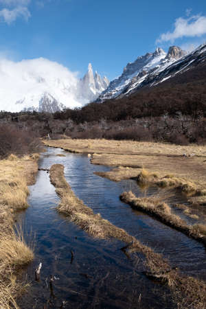 A walking track in Patagonia, near the village of El Chalten, Argentina. In the background is Cerro Torre, a popular destination for climbersの写真素材