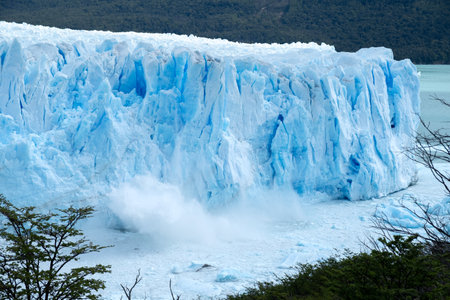 Large pieces of blue ice falling down from Perito Moreno glacier. An ongoing natural process and not a result of global warming, as many people think. The sight and sound are spectacularの写真素材