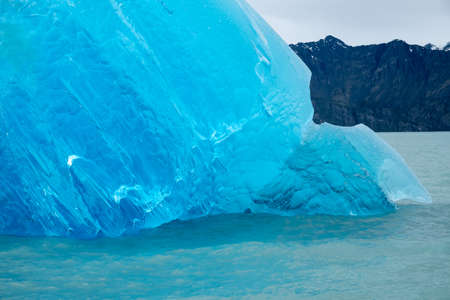Large pieces of intense blue ice drifting in the lakes of Los Glaciares National Park. Most famous attraction here is the Perito Moreno glacier. The ice is bright blue with facsinating stucturesの写真素材