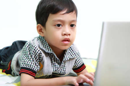 Kid Playing Computer Seriously の写真素材