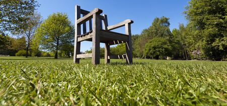 Garden chair on the green meadowの写真素材