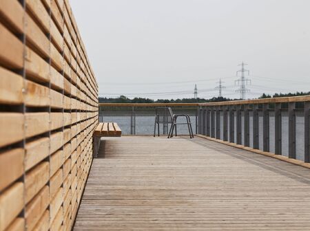 Boardwalk with a garden chairの写真素材
