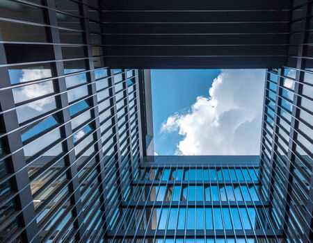 View through a high-rise building to heavenの写真素材