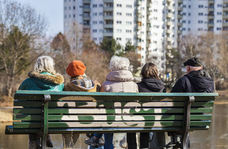 Seniors sitting on a wooden benchの写真素材