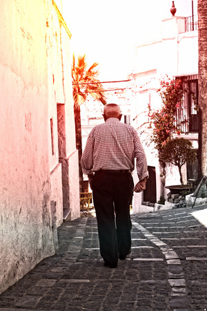 old man taking a walk on a hot dayの写真素材