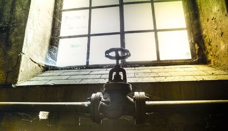 Faucet in an old factoryの写真素材