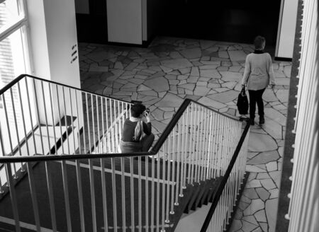 a woman sitting in the stairwellの写真素材