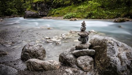 Stack of stones on a riverの写真素材