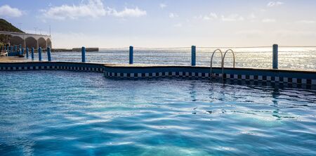 swimming pool by the sea in madeiraの写真素材