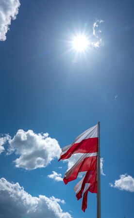 The flag of Poland in front of blue sky