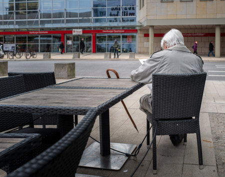 Senior with walking stick restingのeditorial素材