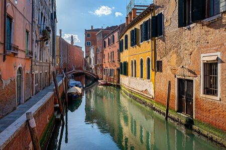 Residential houses, water channels, sights, boats and tourists in Venice, Italyの写真素材