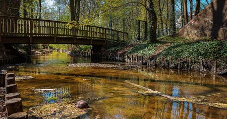 Small river with wooden bridgeの写真素材