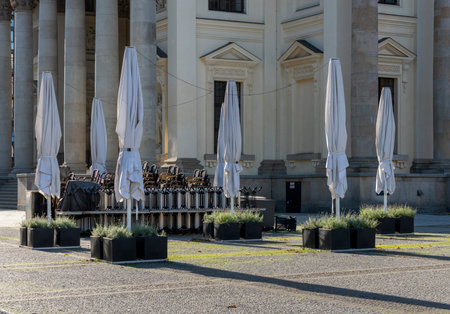 Closed umbrella and dining tables in Berlinのeditorial素材