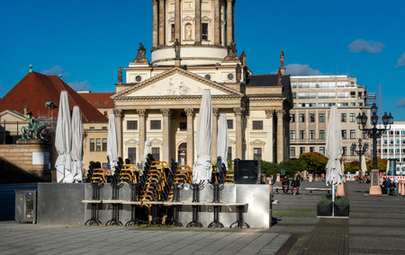 Closed umbrella and dining table outside a building in Berlinのeditorial素材