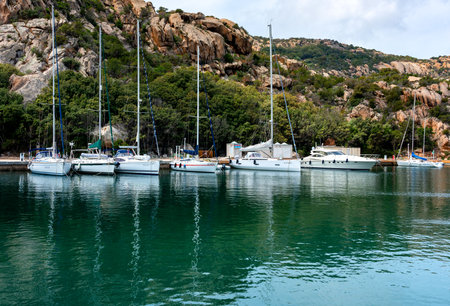 sailboats and yachts in a small port on the island of sardiniaのeditorial素材
