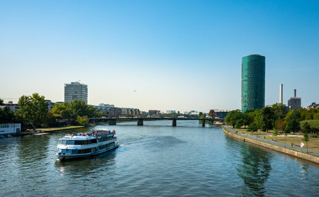 the westahfentower in frankfurt with the main river and a boat for tours in the foregroundのeditorial素材