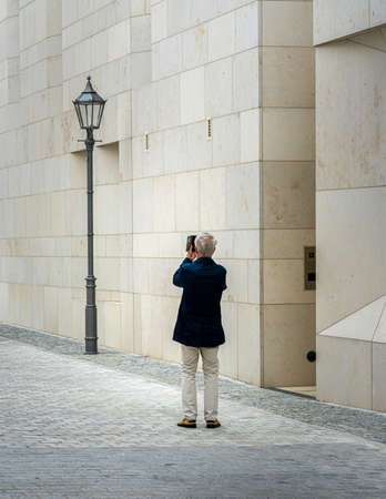 Photographer with cell phone photographs a lanternの写真素材