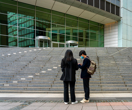 young Asian couple in front of the Commerzbank headquarters in Frankfurt am Mainのeditorial素材