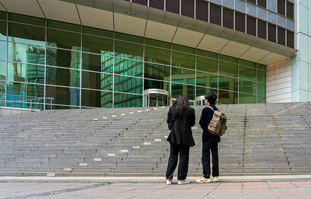 young Asian couple in front of the Commerzbank headquarters in Frankfurt am Mainのeditorial素材