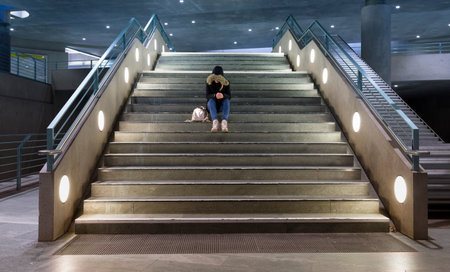 Berlin, young girl sits on the steps at the train stationのeditorial素材