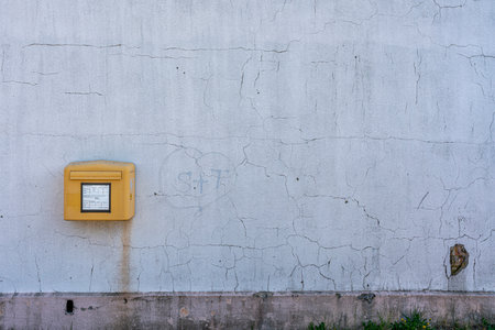 Yellow Deutsche Post mailbox on white wall, Lietzow, Ruegen Islandの写真素材