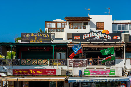 Shops and restaurants on the seafront promenade, Avenida de las Playas, Puerto del Carmen, Lanzarote, Canary Islands, Spainのeditorial素材