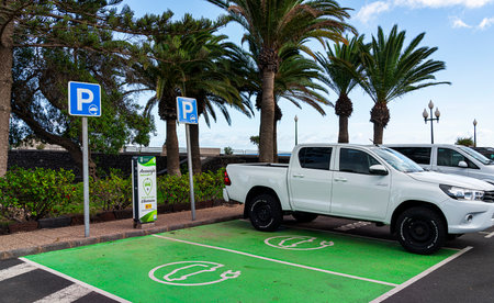 green parking area with Iberdrola charging station for electric car, Lanzarote, Canary Islands, Spainのeditorial素材