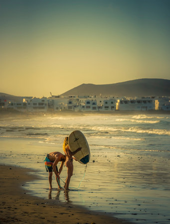 Surfers on the beach, Playa Famara, Lanzarote, Canary Islands, Spainのeditorial素材