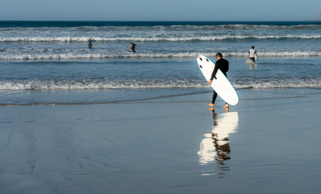 Surfers on the beach, Playa Famara, Lanzarote, Canary Islands, Spainのeditorial素材