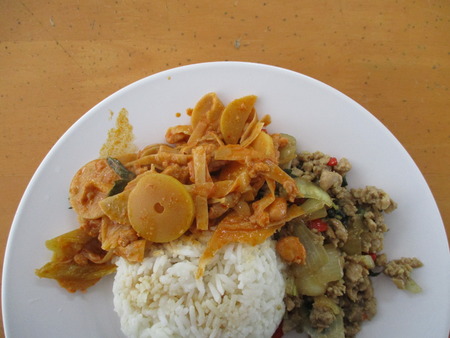 Stirred fried bamboo shoots with pork and stirred fried basil leaves with pork served with rice.の写真素材