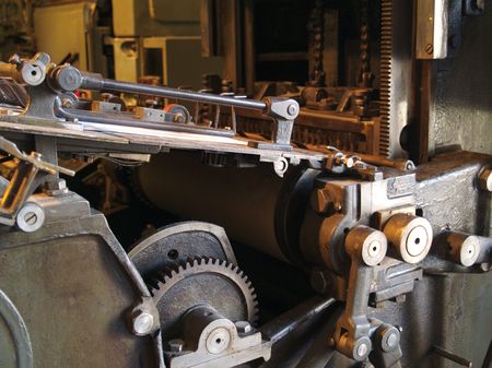 Old printing press with cogs, bars, wheels and leversの写真素材