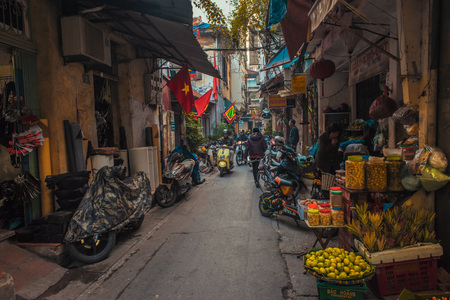 Hanoi, Vietnam - January 23, 2017 - A side street, in the old quarter, where food stalls, are set up , outside shops.のeditorial素材