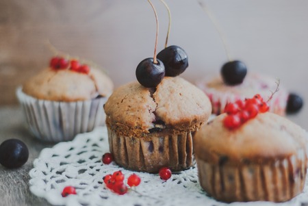 sweet homemade muffins stuffed with cherries and red currantの写真素材