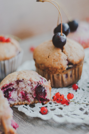 sweet homemade muffins stuffed with cherries and red currantの写真素材