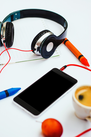 Top view accessories office desk.smartphones headphones on white background with copy space.の写真素材