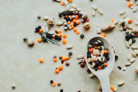 wooden spoon with mix of spices, cereals and beans on a rustic background. concept of healthy foodの写真素材