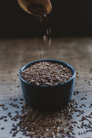 Bowl full of brown flaxseed or linseed. Cereals. Vitamins. Healthy food.の写真素材
