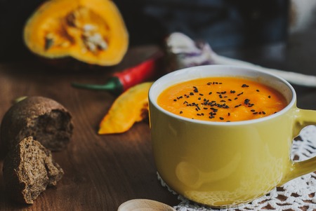 Homemade vegetable soup with pumpkin with cream and black sesame, top view with copy spaceの写真素材