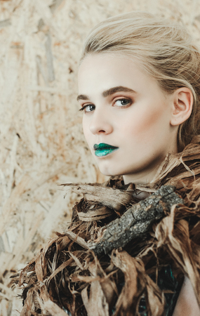 Fashion portrait of Young blond woman.Beautiful Girl with green lips. Concept Mother Natureの写真素材