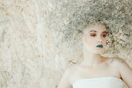 Fashion portrait of Young blond woman in white dress .Beautiful woman with green lipsの写真素材