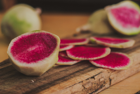 Freshly harvested organic watermelon radish on wooden background
