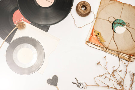 Stack of scratched dusty old vinyl records tied with rope on white backgroundの写真素材